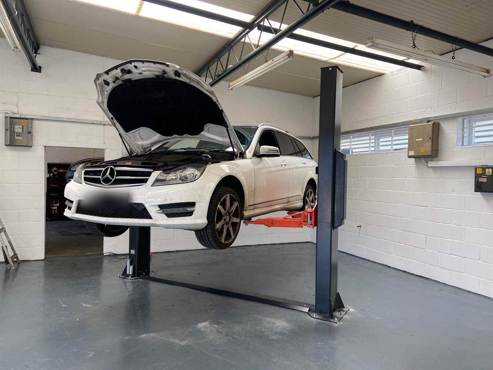 A car raised on a ramp for work underneath